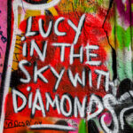 Lennon Wall graffiti in Prague Czech Republic that says Lucy in the Sky with Diamonds