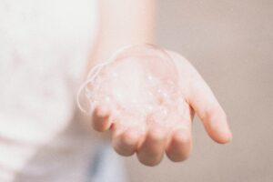 Photo of person holding a soap bubble