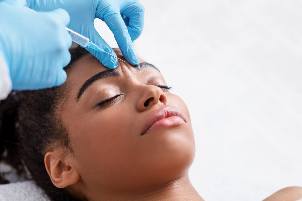 Photo of a black woman getting a botox injection