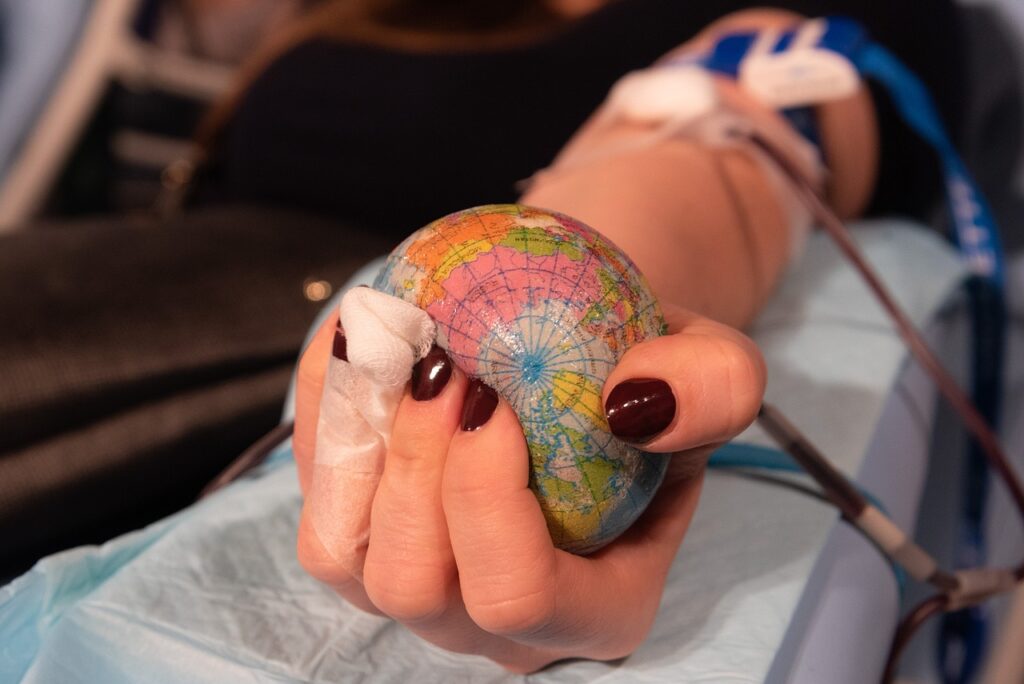 Photo of patient having blood removed intravenously