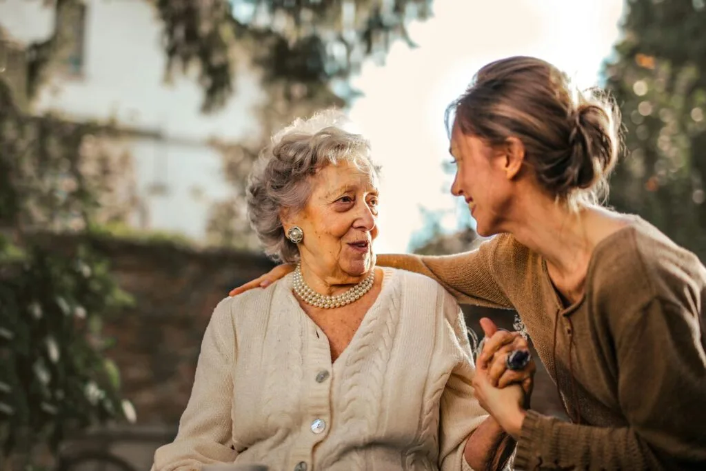 Elderly woman and adult daughter caregiver